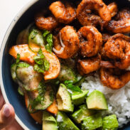 Spicy shrimp in a bowl with rice and peach salad.