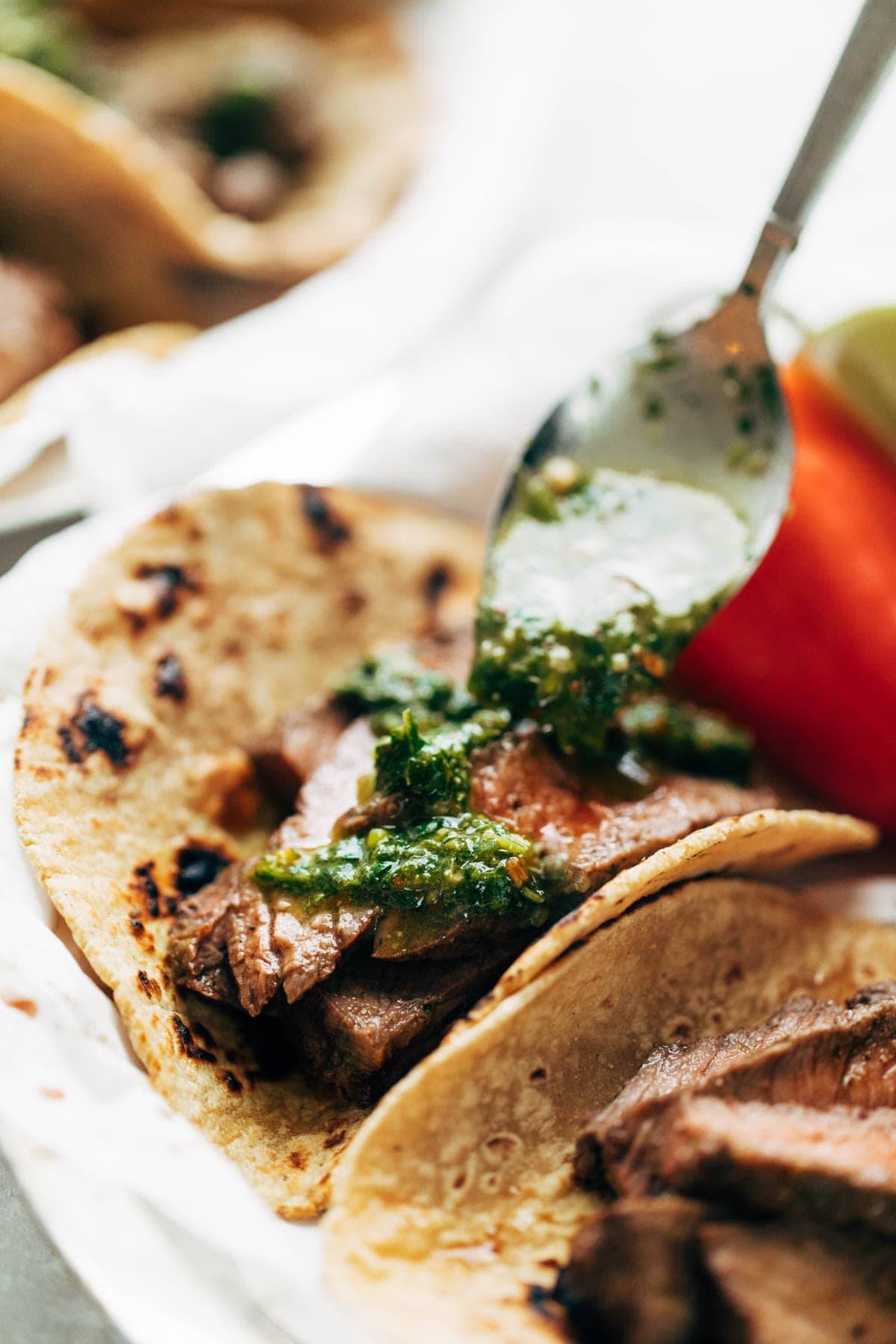 Chimichurri Steak Tacos drizzled with chimi sauce