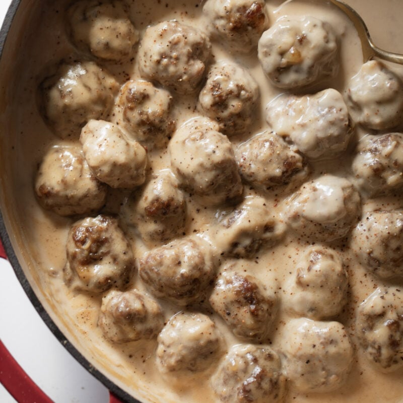 Swedish meatballs in gravy in a skillet.