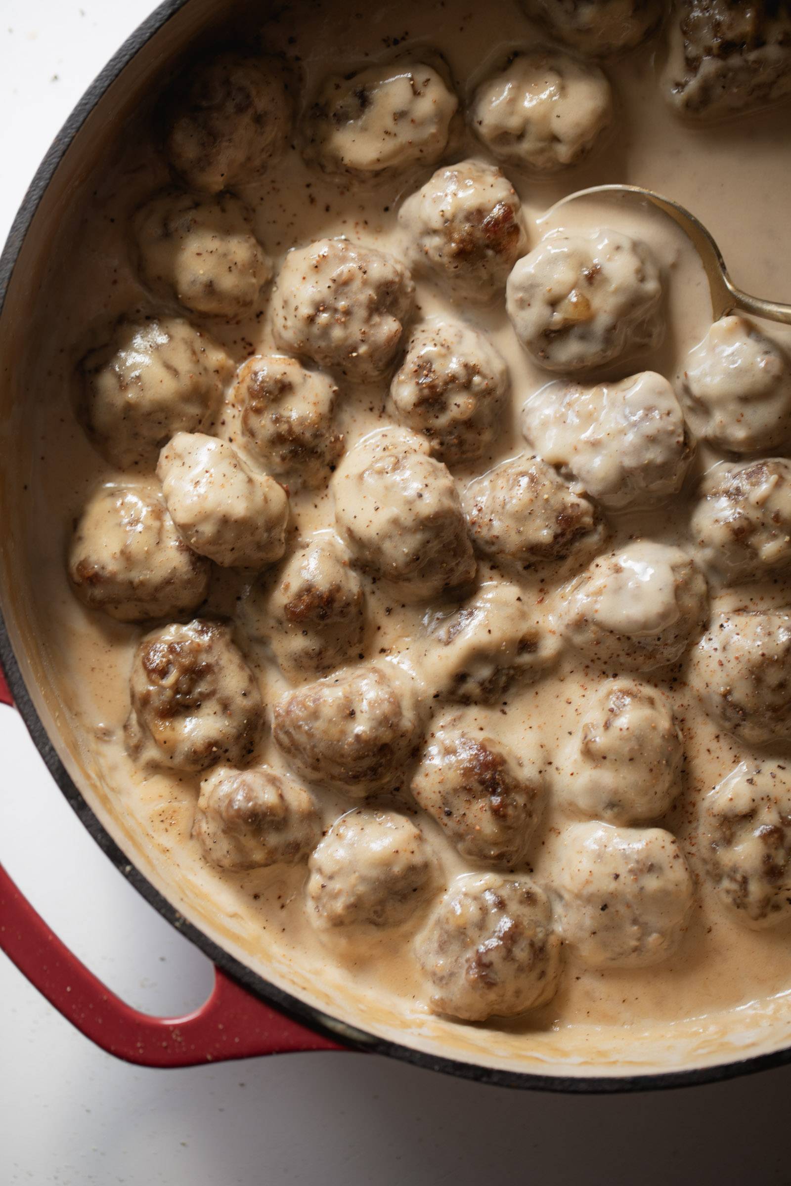 Swedish meatballs in gravy in a skillet.