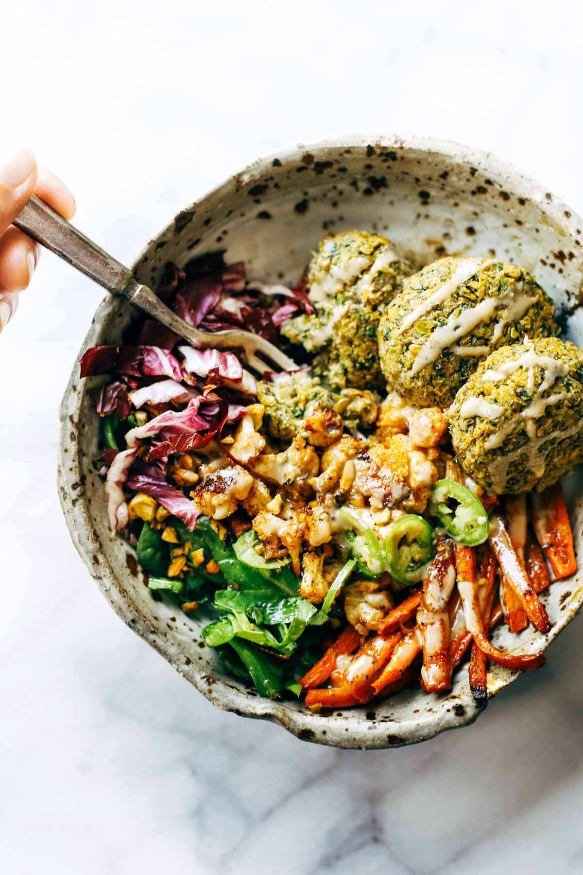 Keep your glow all winter! Easy homemade falafel, roasted veggies, and flavorful sauce all in one big bliss bowl! vegetarian / vegan / gluten free recipe. | pinchofyum.com