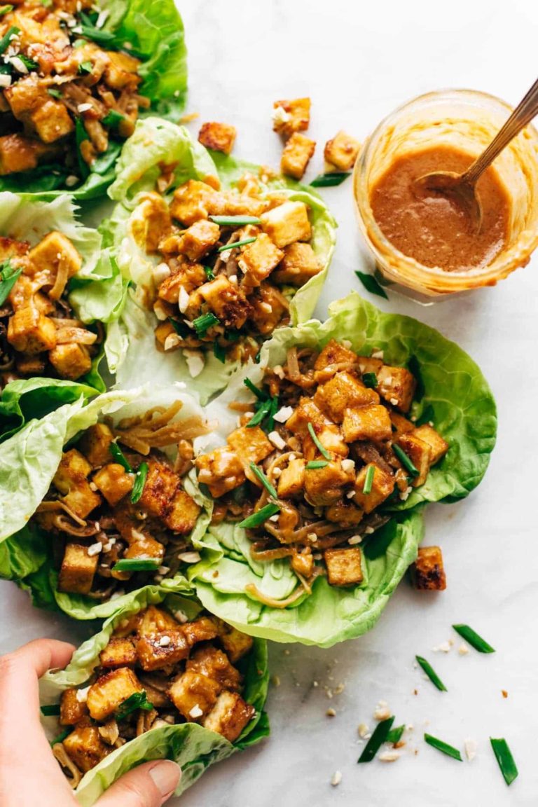 Firecracker Vegan Lettuce wraps in a row with hand.