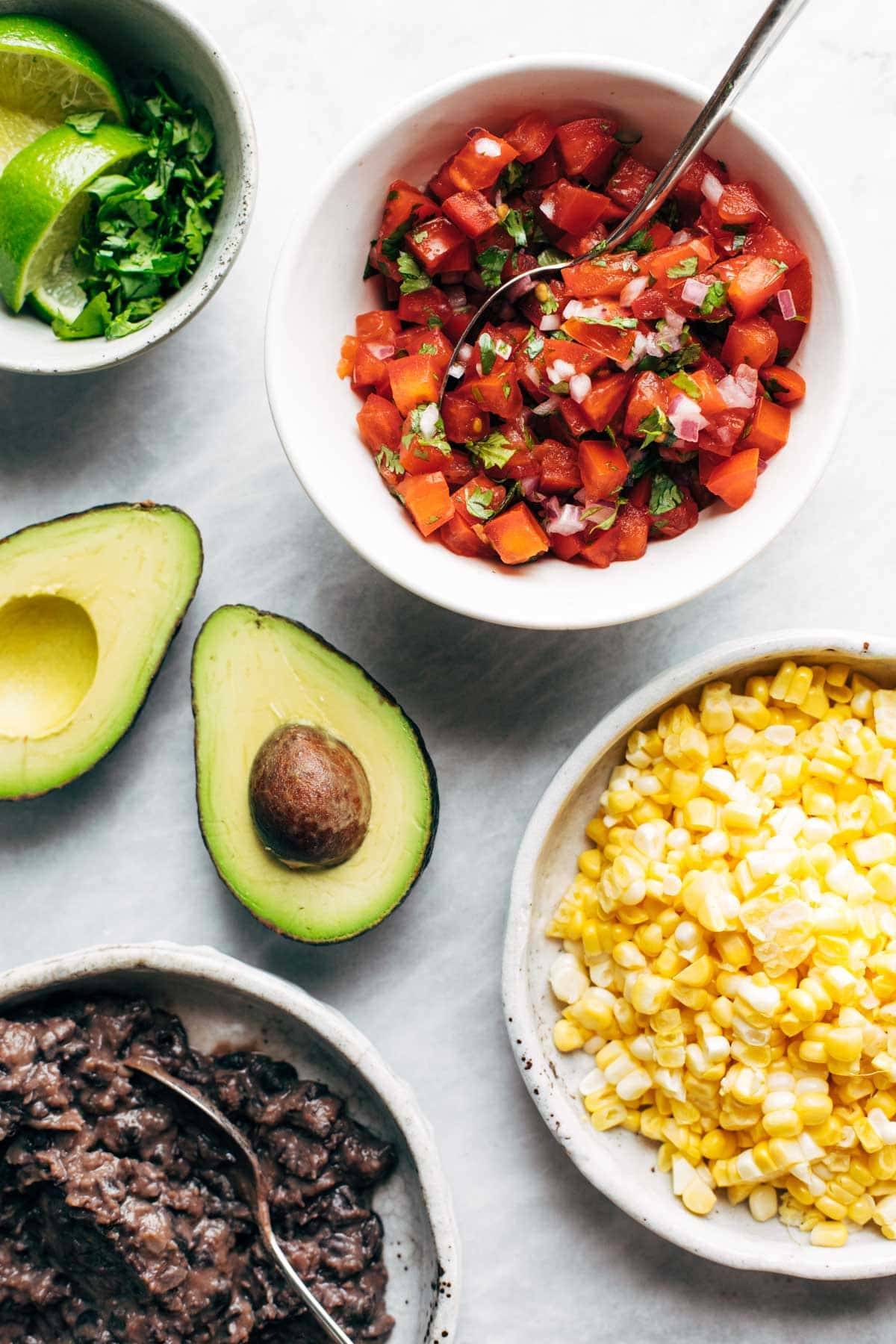 Pico de gallo, corn, beans, and avocado for Cauliflower Burrito Bowls.