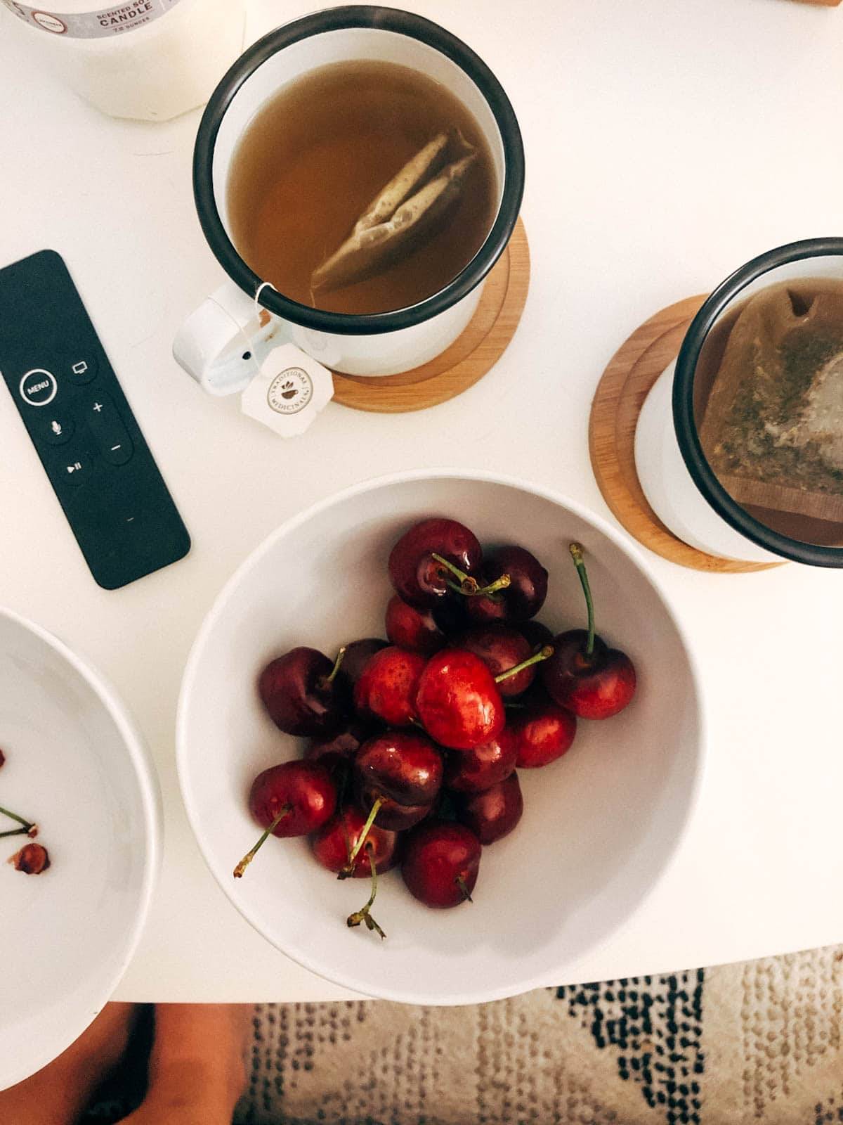 Berries in a bowl near a cup of coffee.