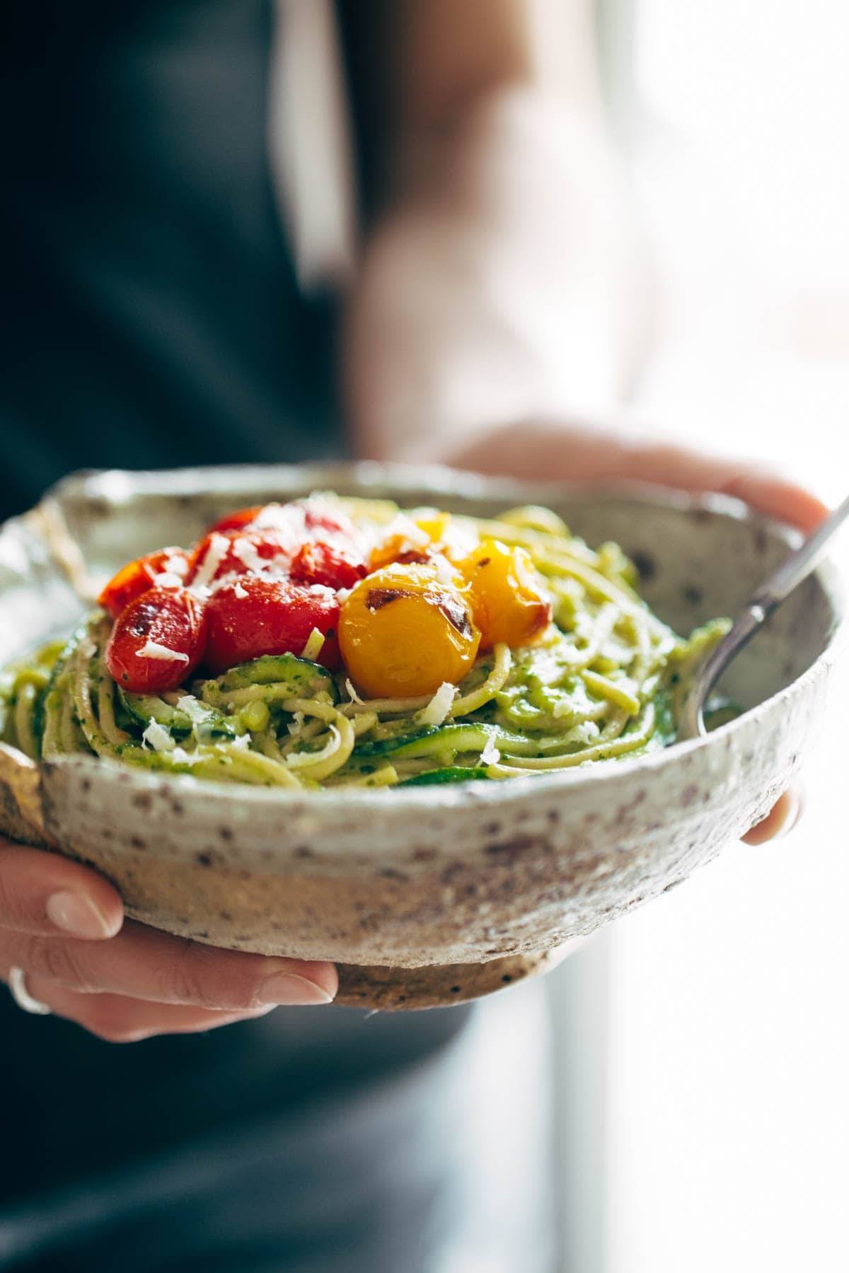 Burst Tomato and Zucchini Spaghetti in a bowl with a fork.