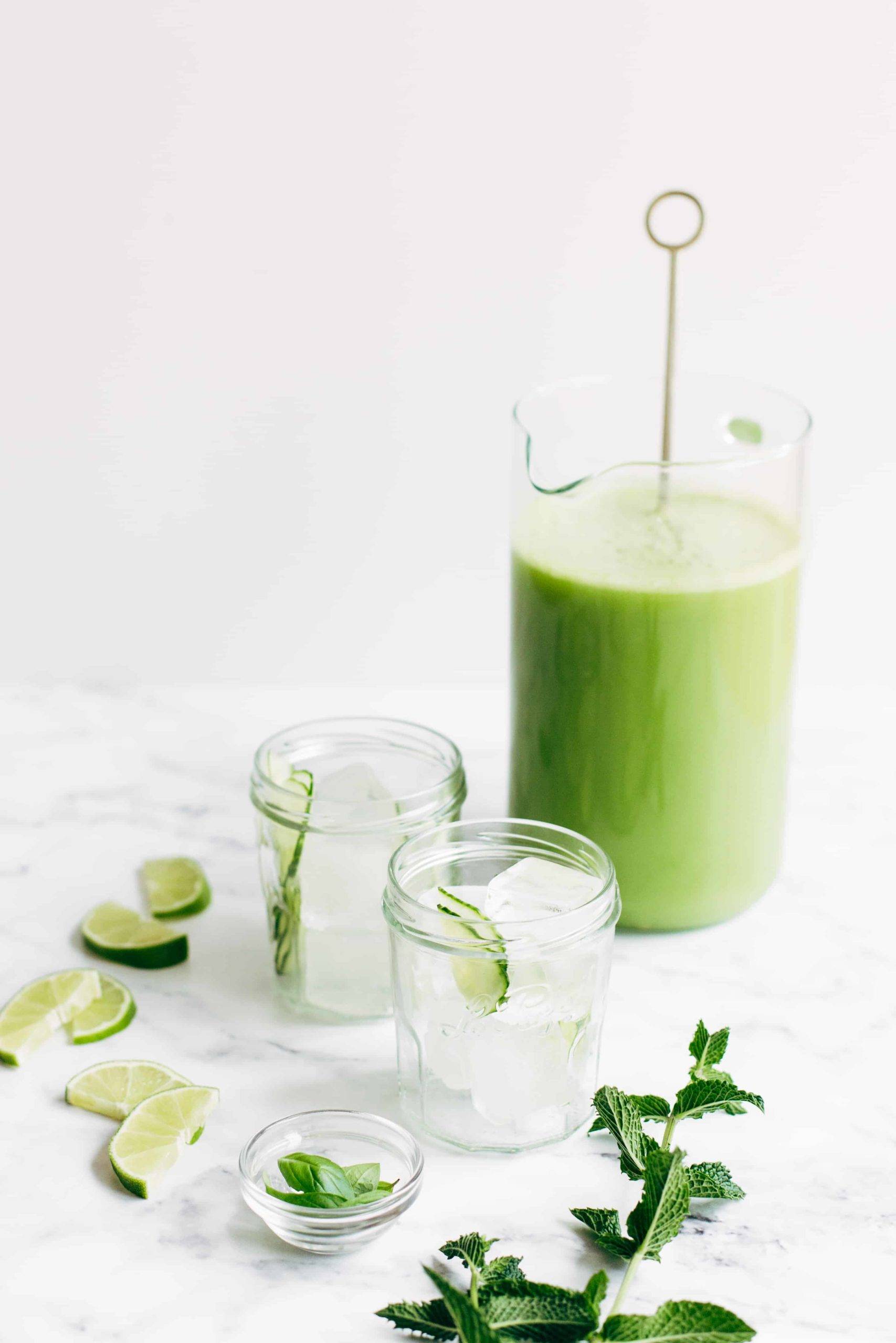 Cucumber agua fresca in a pitcher with ice-filled glasses.