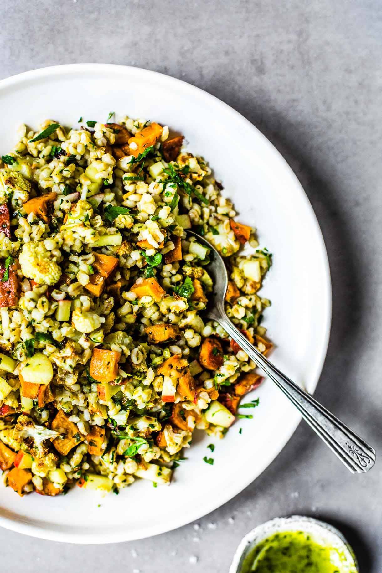 Autumn glow salad in bowl with spoon.