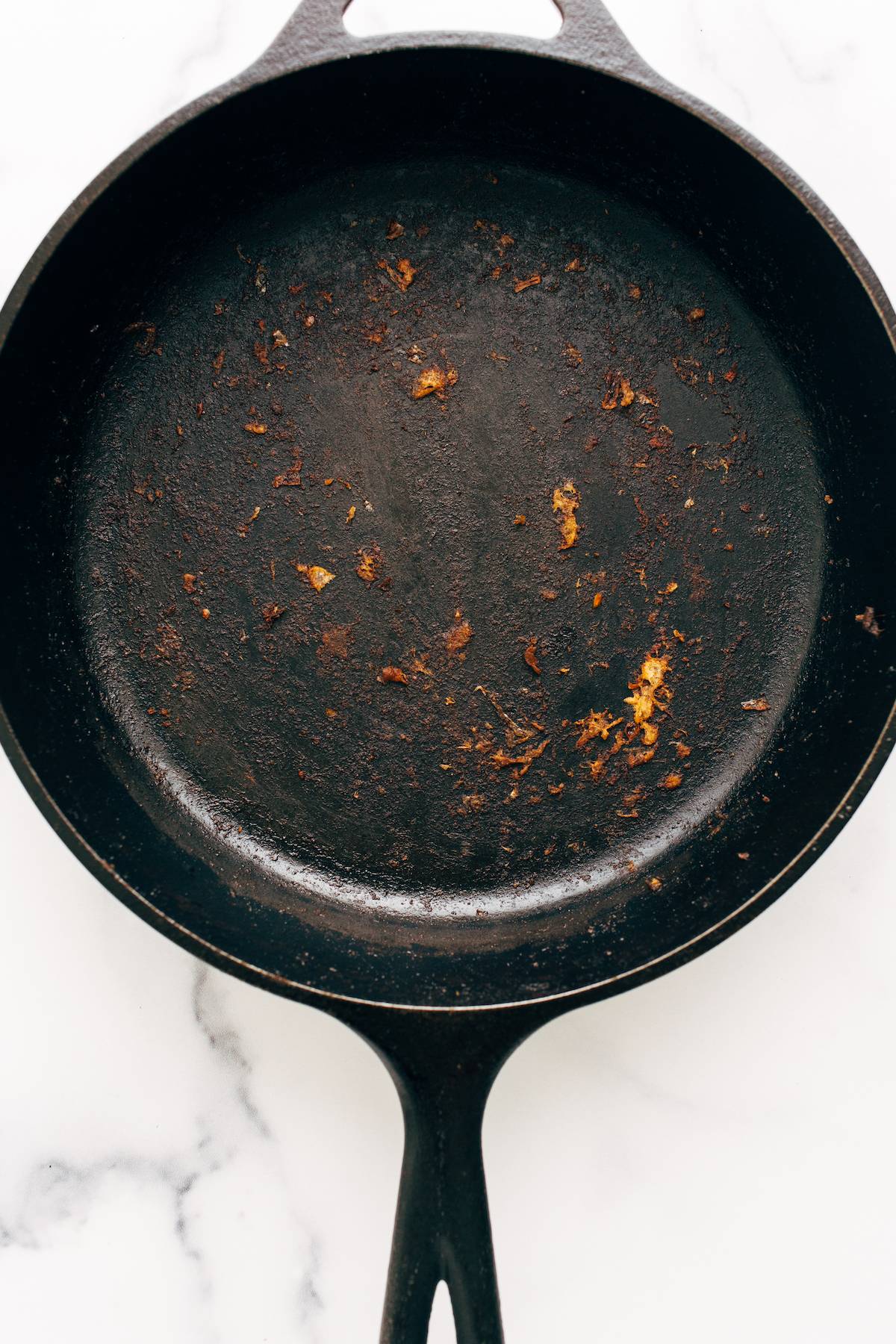 Crusty food stuck on a cast iron skillet.