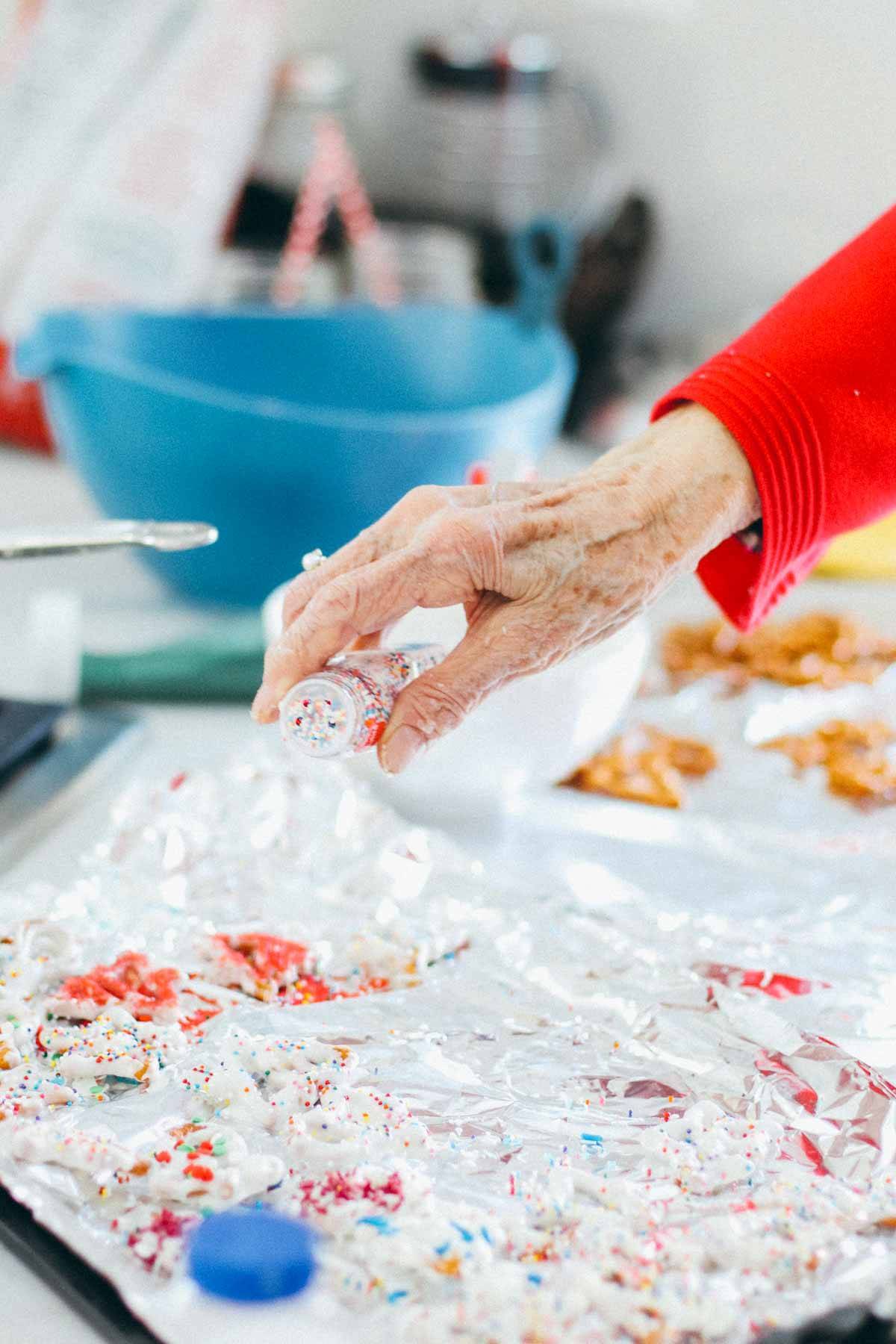 Pouring sprinkles.