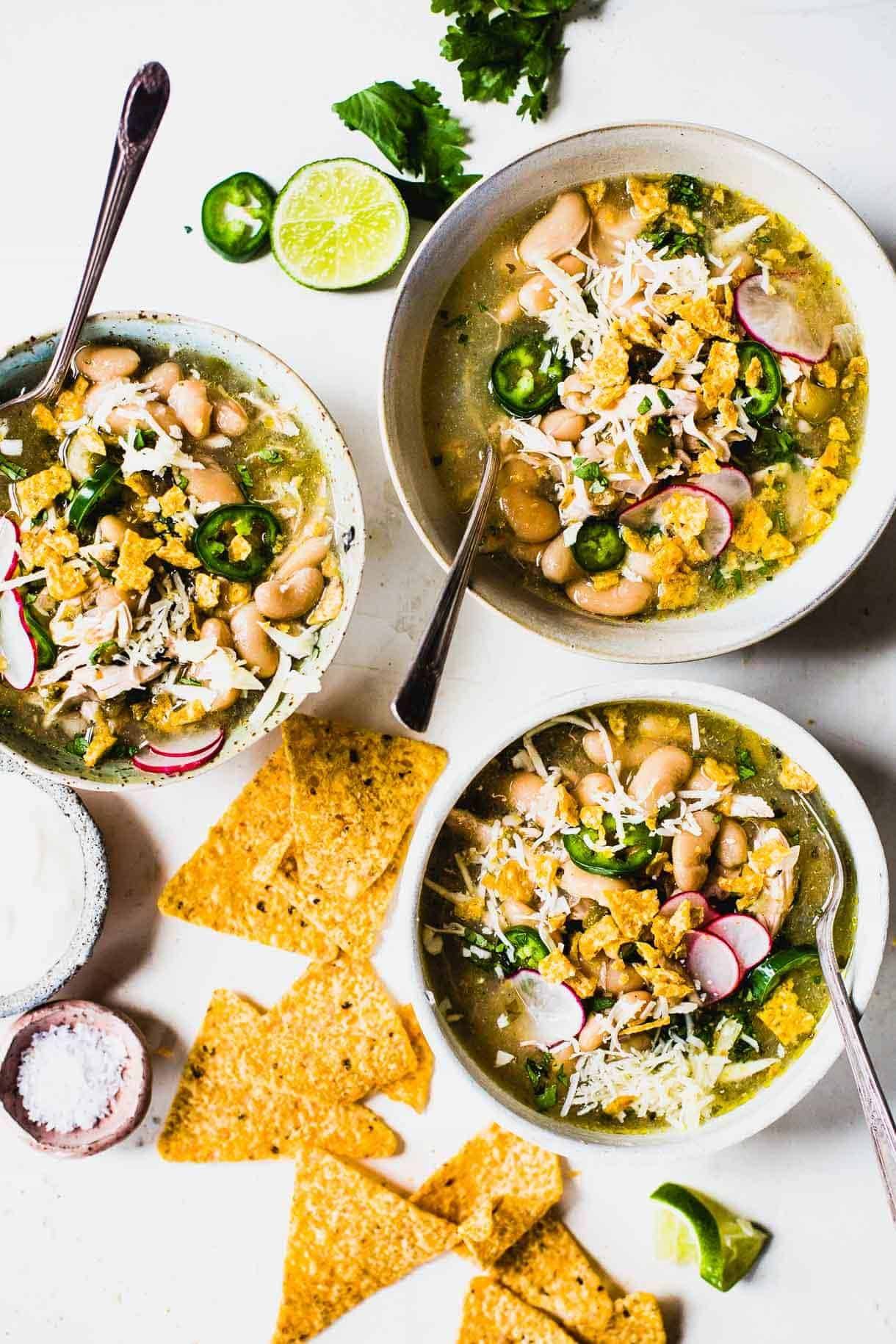 Jalapeño lime chicken soup in bowls with tortilla chips.