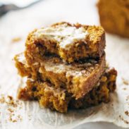 Pumpkin Bread in a stack with butter.