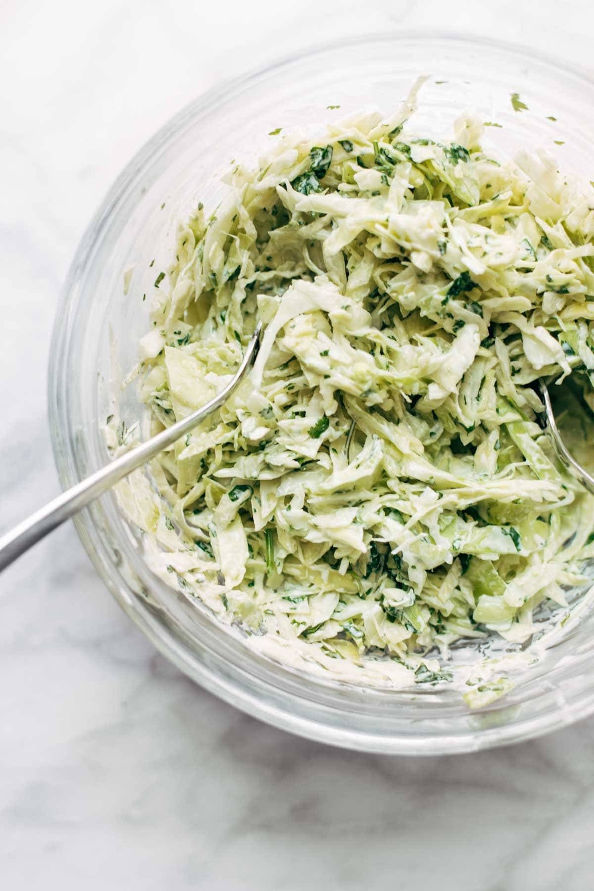 Slaw for salmon burgers in a mixing bowl.